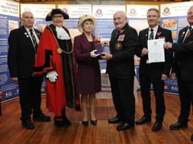 The Lord Lieutenant of Tyne and Wear Mrs Susan Winfield OBE presents the Queen’s Award for Voluntary Service to Tom Fennelly, Honorary Secretary, who received it on behalf of South Shields Volunteer Life Brigade while Senior Brigade Captain Mark Taylor (second right) and Captain Dave Ratcliffe display the official document of conferment of the Award signed by Her Majesty The Queen. Also pictured are Brigade Honorary Treasurer Martin Robertson and the Mayor of South Tyneside Councillor Mrs Pat Hay who officially welcomed the Lord Lieutenant to the ceremony at the Watch House.