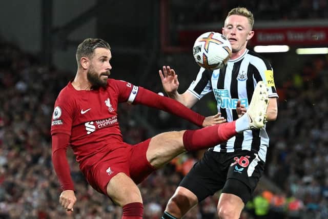 Liverpool's English midfielder Jordan Henderson (L) vies with Newcastle United's English midfielder Sean Longstaff (R) during the English Premier League football match between Liverpool and Newcastle United at Anfield in Liverpool, north west England on August 31, 2022.(Photo by PAUL ELLIS/AFP via Getty Images)