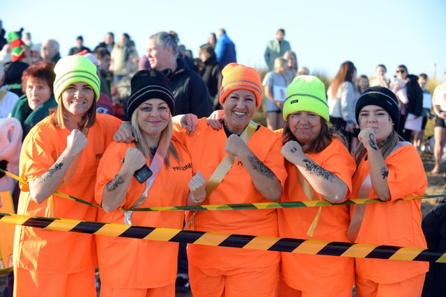 Participants dressed in prison fancy dress ready to take the dip