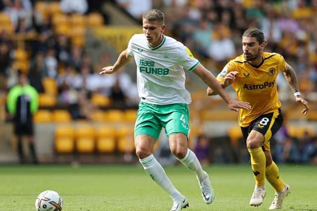 Sven Botman of Newcastle United is put under pressure by Ruben Neves of Wolverhampton Wanderers  during the Premier League match between Wolverhampton Wanderers and Newcastle United at Molineux on August 28, 2022 in Wolverhampton, England. (Photo by David Rogers/Getty Images)