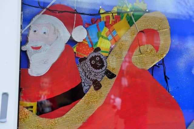 Look closely. Santa has a messy sheep on board.