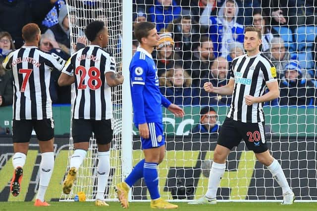 Newcastle United's New Zealand striker Chris Wood (R) celebrates after scoring the opening goal from the penalty spot during the English Premier League football match between Leicester City and Newcastle United at King Power Stadium in Leicester, central England on December 26, 2022. (Photo by LINDSEY PARNABY/AFP via Getty Images)