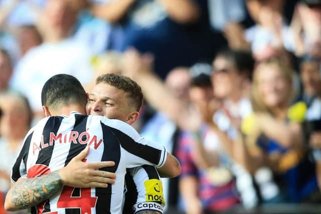Newcastle United's English defender Kieran Trippier (rear) celebrates with Newcastle United's Paraguayan midfielder Miguel Almiron after scoring his team third goal during the English Premier League football match between Newcastle United and Manchester City at St James' Park in Newcastle-upon-Tyne, north east England, on August 21, 2022.
