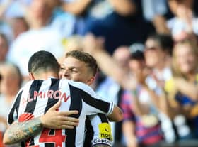 Newcastle United's English defender Kieran Trippier (rear) celebrates with Newcastle United's Paraguayan midfielder Miguel Almiron after scoring his team third goal during the English Premier League football match between Newcastle United and Manchester City at St James' Park in Newcastle-upon-Tyne, north east England, on August 21, 2022.