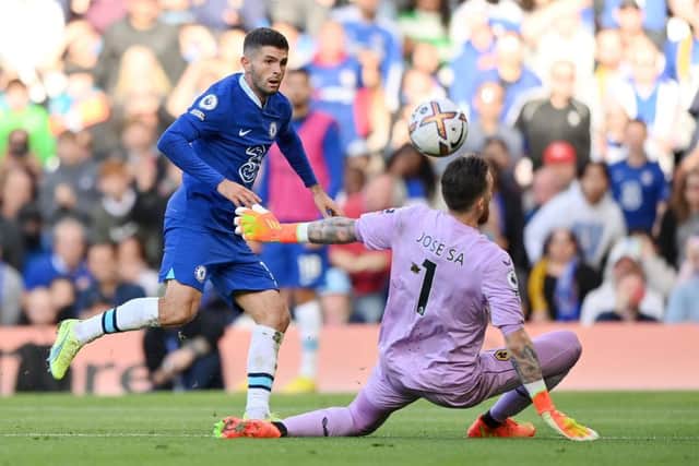 Christian Pulisic of Chelsea scores their side's second goal past Jose Sa of Wolverhampton Wanderers during the Premier League match between Chelsea FC and Wolverhampton Wanderers at Stamford Bridge on October 08, 2022 in London, England. (Photo by Justin Setterfield/Getty Images)
