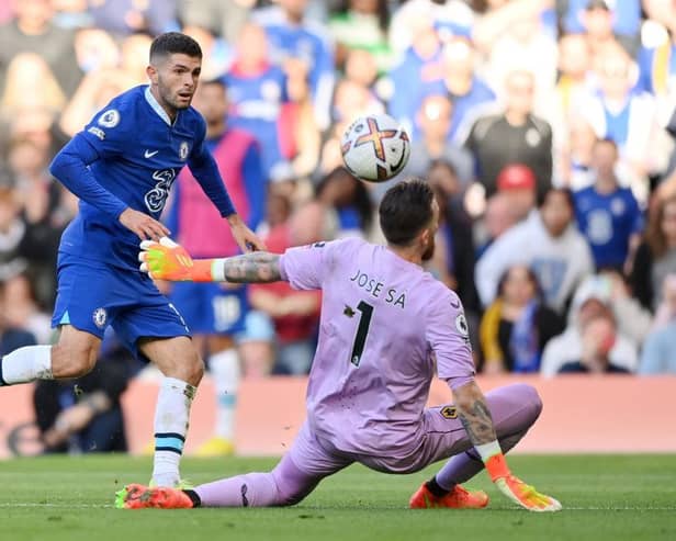 Christian Pulisic of Chelsea scores their side's second goal past Jose Sa of Wolverhampton Wanderers during the Premier League match between Chelsea FC and Wolverhampton Wanderers at Stamford Bridge on October 08, 2022 in London, England. (Photo by Justin Setterfield/Getty Images)