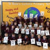 Children from St Bede's Catholic Primary School celebrate being awarded the Early Years Quality Mark.