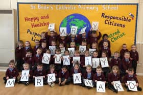 Children from St Bede's Catholic Primary School celebrate being awarded the Early Years Quality Mark.