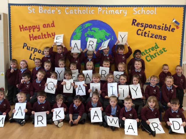 Children from St Bede's Catholic Primary School celebrate being awarded the Early Years Quality Mark.
