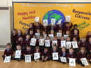 Children from St Bede's Catholic Primary School celebrate being awarded the Early Years Quality Mark.