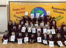 Children from St Bede's Catholic Primary School celebrate being awarded the Early Years Quality Mark.