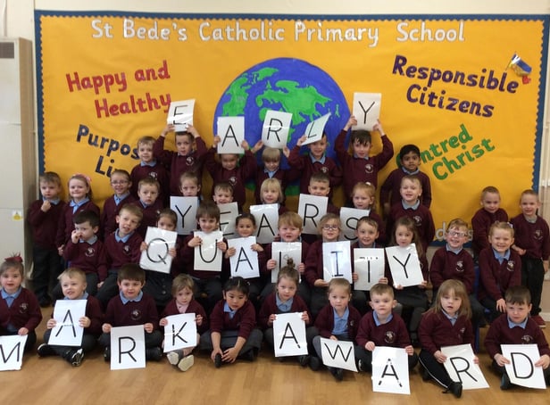 Children from St Bede's Catholic Primary School celebrate being awarded the Early Years Quality Mark.