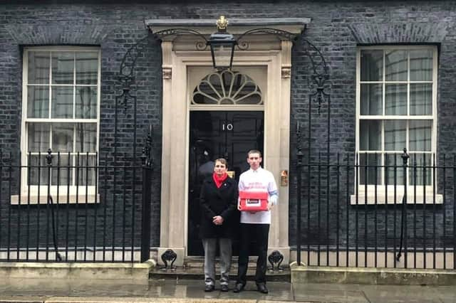 Christopher Head and Kate Osborne MP hand over the petition at 10 Downing Street.