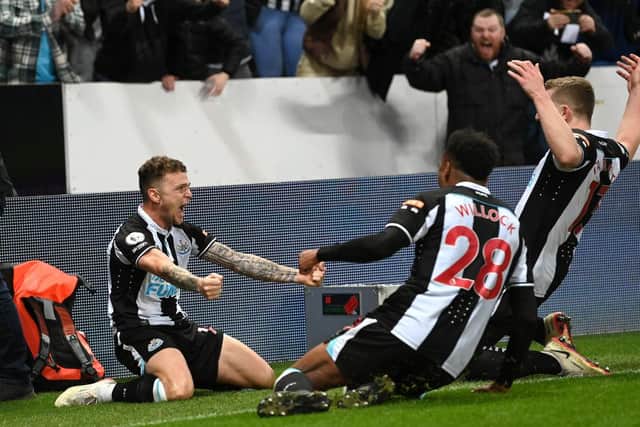 Newcastle player Kieran Trippier celebrates with team mates after scoring the third goal from a free kick during the Premier League match between Newcastle United  and  Everton at St. James Park on February 08, 2022 in Newcastle upon Tyne, England. (Photo by Stu Forster/Getty Images)