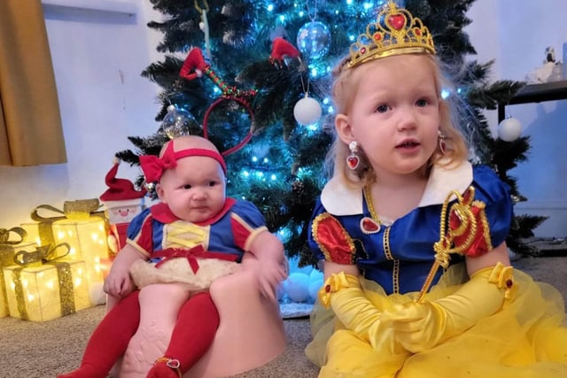 Connie, age 7 months, and Myla, age 2, are ready to celebrate their first Christmas together.