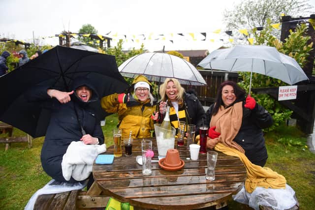 Fans braving the elements to watch Hebburn Town beat Consett at Wembley on the big screen at Hebburn Sports Club back in May