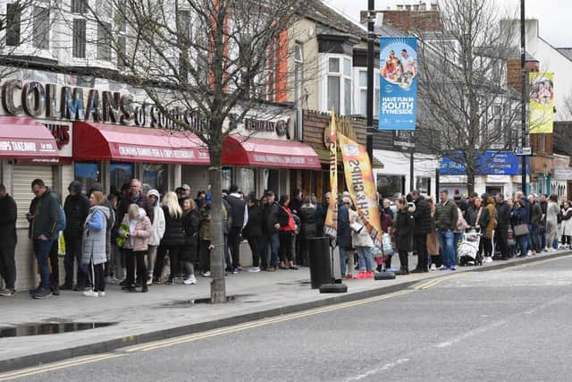 The Good Friday fish and chip customers queue along Ocean Road.