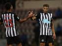 Joelinton celebrates scoring with Jacob Murphy.