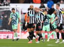 Bruno Guimaraes leaves the pitch in tears, consoled by Joelinton of Newcastle United at half time during the Premier League match between Newcastle United and Fulham FC at St. James Park on January 15, 2023 in Newcastle upon Tyne, England. (Photo by Stu Forster/Getty Images)