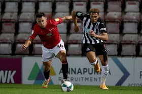 John O'Sullivan of Morecambe battles for possession with Newcastle United's Joelinton.