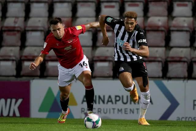 John O'Sullivan of Morecambe battles for possession with Newcastle United's Joelinton.