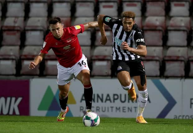 John O'Sullivan of Morecambe battles for possession with Newcastle United's Joelinton.