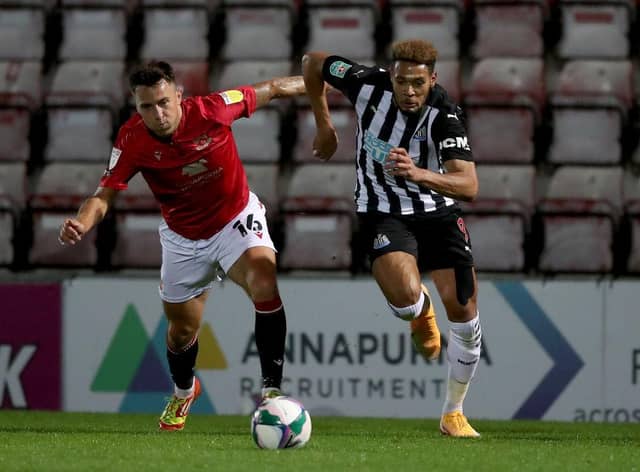 John O'Sullivan of Morecambe battles for possession with Newcastle United's Joelinton.