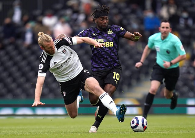 Fulham's Tim Ream (left) and Newcastle United's Allan Saint-Maximin (right) battle for the ball during the Premier League match at Craven Cottage, London. Picture date: Sunday May 23, 2021.