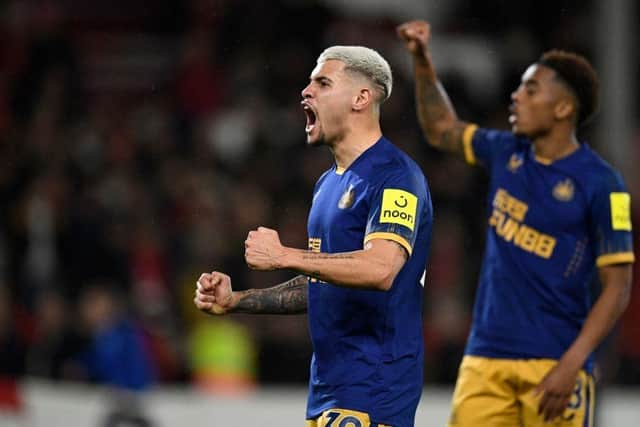 Newcastle United's Brazilian midfielder Bruno Guimaraes (C) celebrates on the pitch after the English Premier League football match between Nottingham Forest and Newcastle United at The City Ground in Nottingham, central England, on March 17, 2023. - Newcastle won the game 2-1. (Photo by Oli SCARFF / AFP)