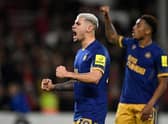 Newcastle United's Brazilian midfielder Bruno Guimaraes (C) celebrates on the pitch after the English Premier League football match between Nottingham Forest and Newcastle United at The City Ground in Nottingham, central England, on March 17, 2023. - Newcastle won the game 2-1. (Photo by Oli SCARFF / AFP)