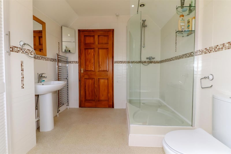 With separate walk-in shower.