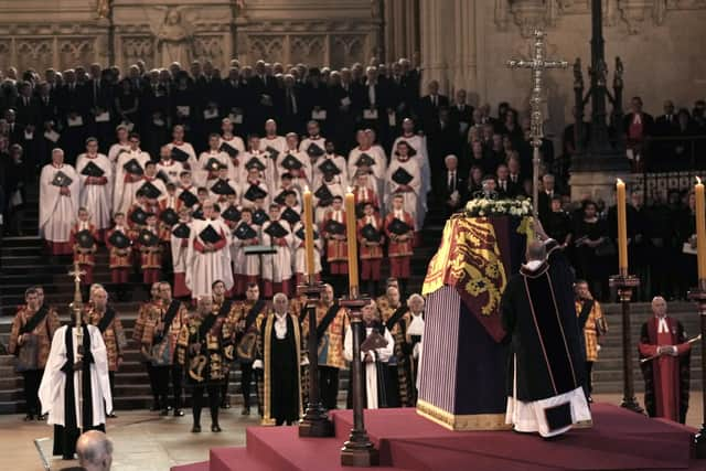 The coffin of Queen Elizabeth II, draped in the Royal Standard with the Imperial State Crown placed on top, lays on the catafalque in Westminster Hall, London, where it will lie in state ahead of her funeral on Monday. Picture date: Wednesday September 14, 2022.