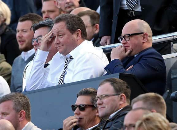 Newcastle United's owner Mike Ashley (C) and managing director Lee Charnley (R) look on ahead of the English Premier League football match between Newcastle United and Tottenham Hotspur at St James' Park in Newcastle-upon-Tyne, north east England on May 15, 2016. / AFP / Scott Heppell        (Photo credit should read SCOTT HEPPELL/AFP via Getty Images)