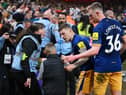Kieran Trippier and Sean Longstaff of Newcastle United speak to a steward and a young fan after the Premier League match between Nottingham Forest and Newcastle United at City Ground on March 17, 2023 in Nottingham, England. (Photo by Laurence Griffiths/Getty Images)