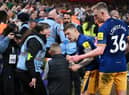 Kieran Trippier and Sean Longstaff of Newcastle United speak to a steward and a young fan after the Premier League match between Nottingham Forest and Newcastle United at City Ground on March 17, 2023 in Nottingham, England. (Photo by Laurence Griffiths/Getty Images)