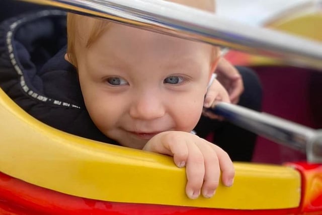 One-year-old Noah enjoys a great day out at the fairground. Look at that happy face!