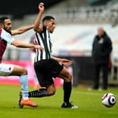 Isaac Hayden of Newcastle United is challenged by Ahmed Elmohamady of Aston Villa during the Premier League match between Newcastle United and Aston Villa at St. James Park on March 12, 2021 in Newcastle upon Tyne, England.