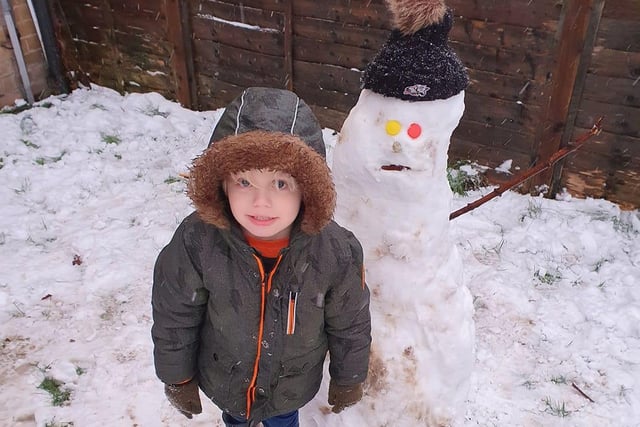 Julie Michelle Kain sent in this photo of her son and his snow man.