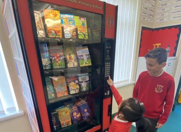 St Joseph's pupils with the book vending machine, dubbed the Dream Big Read Machine