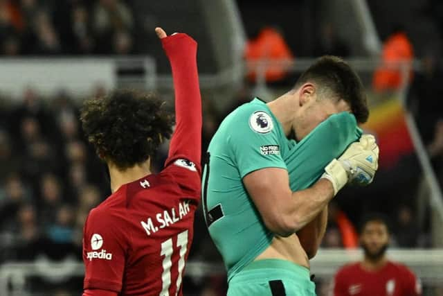 Newcastle United goalkeeper Nick Pope reacts to his dismissal against Liverpool.