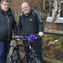Andrew receiving his new bike from Matthew