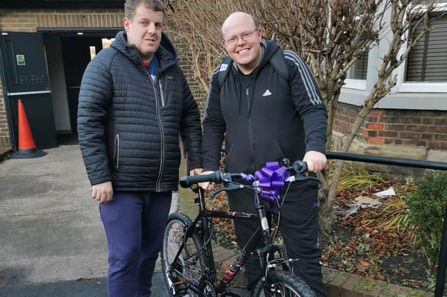 Andrew receiving his new bike from Matthew