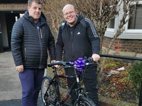Andrew receiving his new bike from Matthew