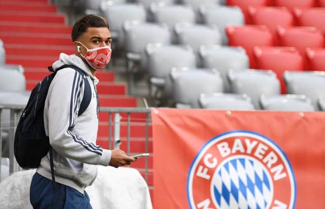 Bayern Munich's French midfielder Corentin Tolisso wears a face protection mask prior to the German first division Bundesliga football match between FC Bayern Munich and Eintracht Frankfurt on May 23, 2020 in Munich.