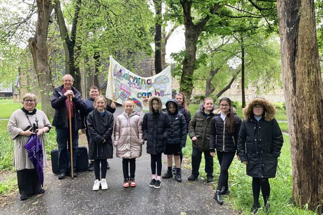 Revd Lesley Jones and Bishop Paul (left) alongside the Jarrow students.