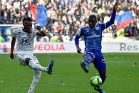 Lyon's Burkinabe forward Bertrand Traore (L) fights for the ball with Strasbourg's Ivorian forward Kevin Zohi (R) during the French L1 football match between Lyon (OL) and Strasbourg (RCSA) on February 16, 2020 at the Groupama Stadium in Decines-Charpieu near Lyon, southeastern France. (Photo by JEAN-PHILIPPE KSIAZEK / AFP) (Photo by JEAN-PHILIPPE KSIAZEK/AFP via Getty Images)