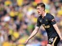 Sean Longstaff playing for Newcastle United at Carrow Road.