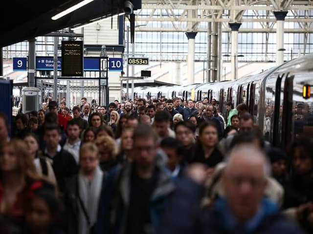 Commuters walk along a packed platform after a single train arrived during the morning rush hour, at Waterloo Station in London on April 8, 2024, as train drivers strike over pay. (Photo by HENRY NICHOLLS / AFP)