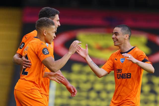Dwight Gayle, left, celebrates his goal with Miguel Almiron.