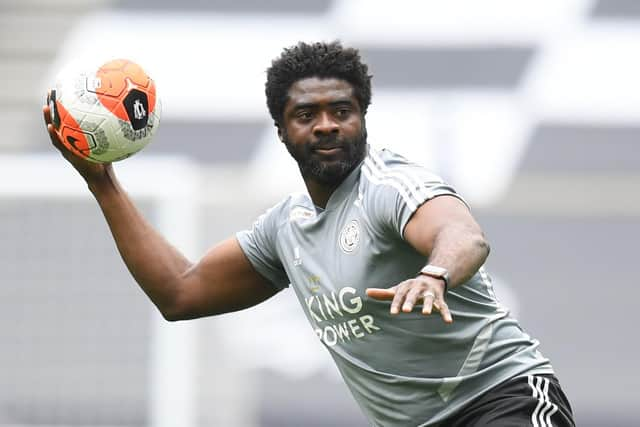 Leicester City's first team coach Kolo Toure warms up the players ahead of the Premier League game against Tottenham Hotspur.